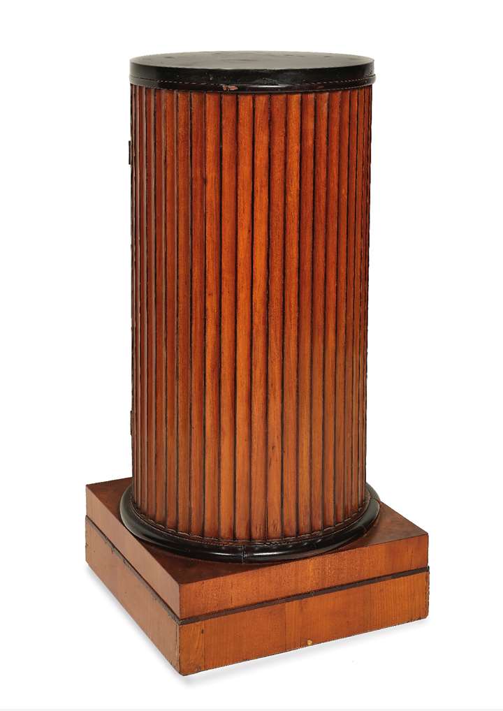 An Italian Neoclassical carved, veneered and ebonized cherry wood cylindrical pedestal cupboard